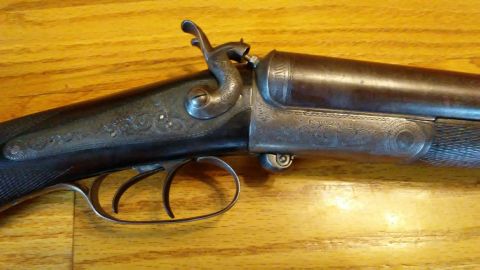 1994 Ford Bronco - Antique double barrel shotgun with detailed engraving on the metal parts.