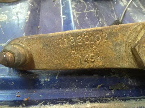 1994 Ford Bronco - Close-up of a rusted metal part showing stamped identification numbers.