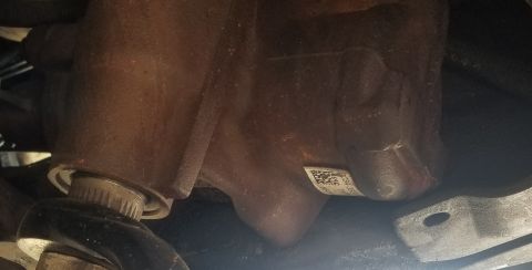 2001 Ford Excursion - Close-up view of a vehicle's steering gear housing, showing a label with a barcode.