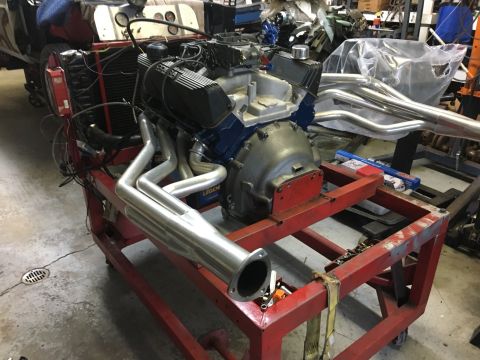 1967 Ford Galaxie - Engine and exhaust system components are displayed on a stand, likely for repair or modification.