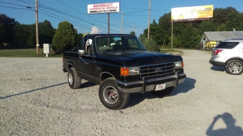 1988 Ford Bronco - This black pickup truck appears to be from the late 1980s, possibly a 1987 model, with a distinctive grille.