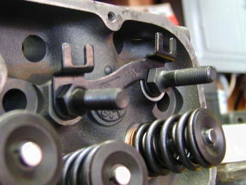 1979 Ford Bronco - Close-up of an engine cylinder head showing internal components like valve springs and a rocker arm assembly.