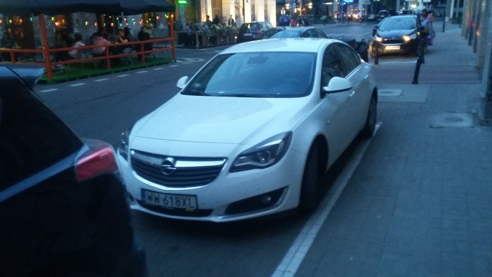 White Opel sedan with license plate WW 618XL parked curbside