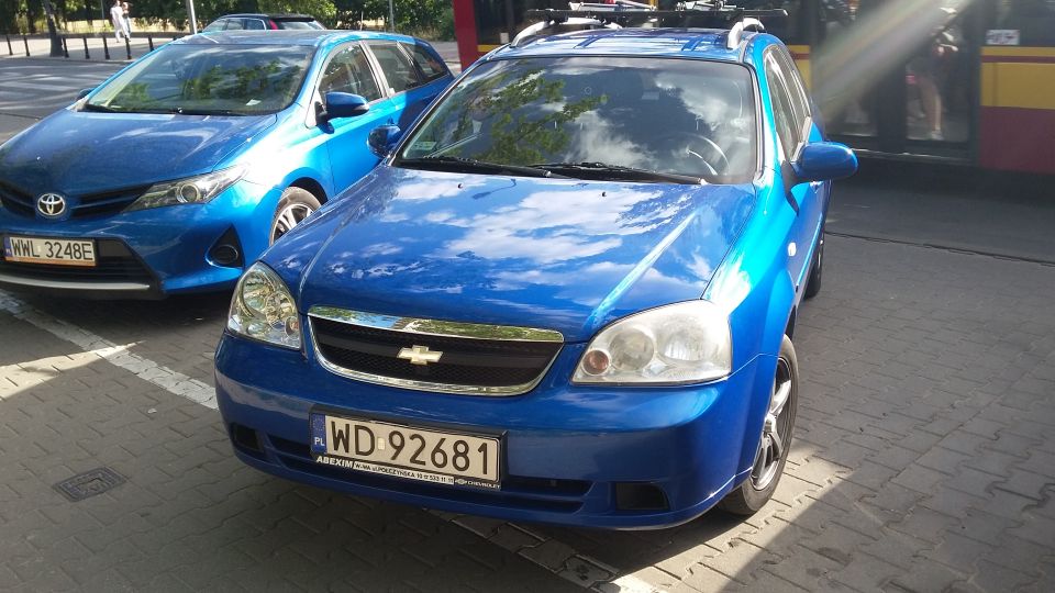 Blue Chevrolet station wagon parked next to a blue Toyota hatchback
