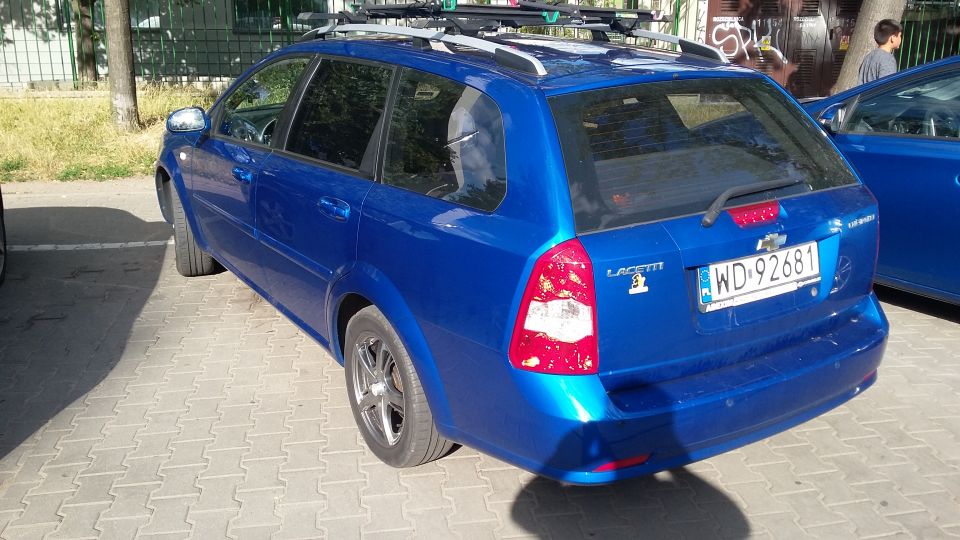 Blue station wagon with roof rack, license plate WD-92681, and 'LACETTI' badging