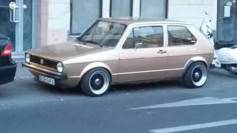 Tan Volkswagen Golf Mk1 with aftermarket wheels and a license plate reading GLE-56PA