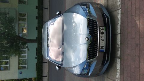 Silver Skoda Octavia parked on a street, front view. License plate WI 614FG