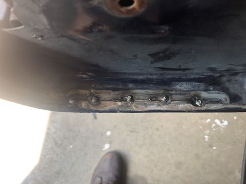 1995 Ford Bronco - Detail of a metal panel showing recent welding repairs.