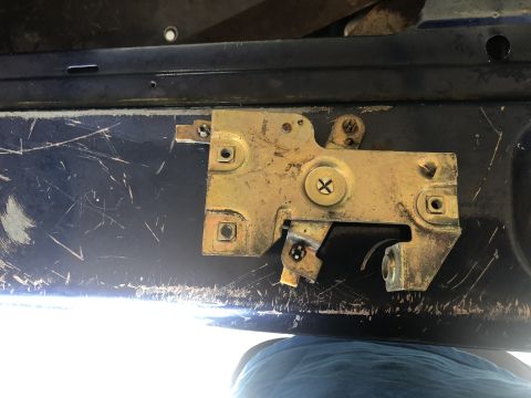 1995 Ford Bronco - Tailgate latch mechanism detail, showing wear and metal components.