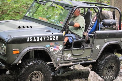 1972 Ford Bronco - This modified Ford Bronco is navigating a rocky trail with a driver behind the wheel.