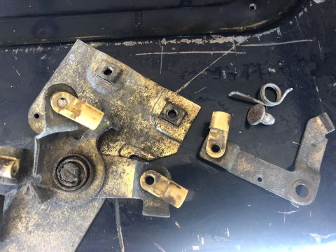 1995 Ford Bronco - Disassembled tailgate latch mechanism parts, likely for repair or replacement.