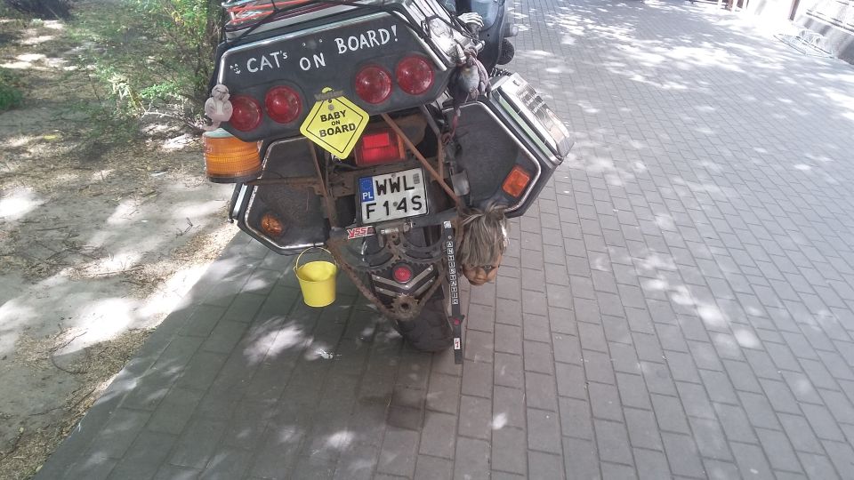 Motorcycle rear with "CAT ON BOARD!" sticker and yellow bucket