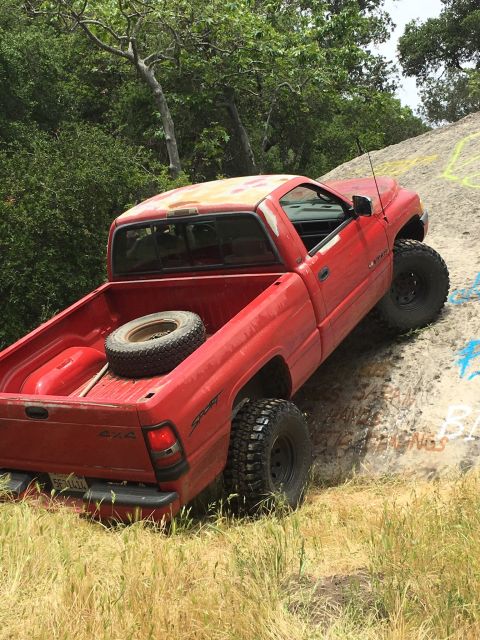 1996 Dodge 1500 - This 1996 Dodge 1500 pickup truck is captured in action while navigating a challenging off-road terrain.