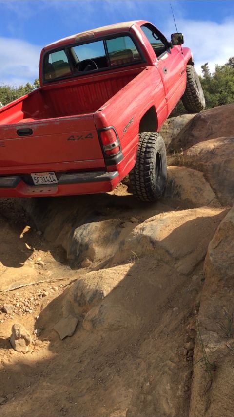 1996 Dodge 1500 - Red 1996 Dodge 1500 4x4 pickup truck navigating a challenging rocky trail.