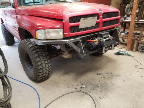 1996 Dodge 1500 - Front view of a red 1996 Dodge 1500 pickup truck with a custom bumper and winch.