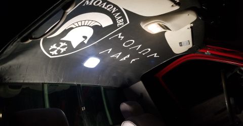1996 Dodge 1500 - The interior ceiling of a vehicle displays a Spartan helmet decal and the phrase Molon Labe.