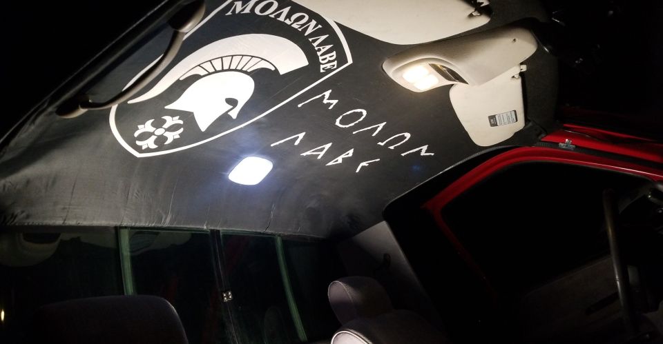 Vehicle interior ceiling with Spartan helmet decal and Molon Labe text. Lights are on