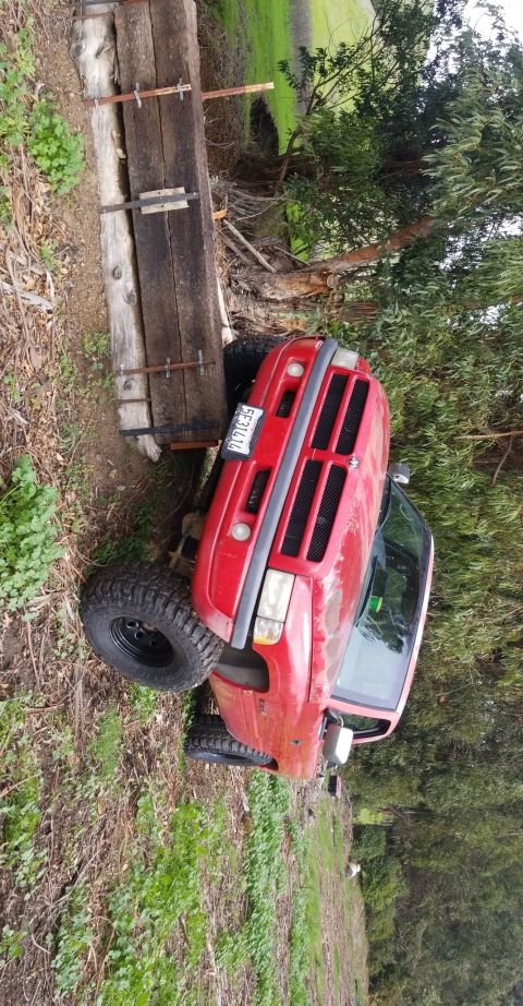 1996 Dodge 1500 - This red 1996 Dodge 1500 pickup truck is shown from a 3q-front angle.
