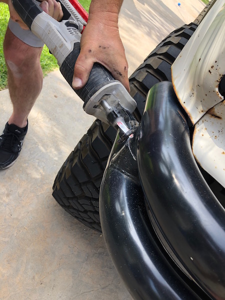 1981 Ford Bronco - Cutting a vehicle bumper with a reciprocating saw.