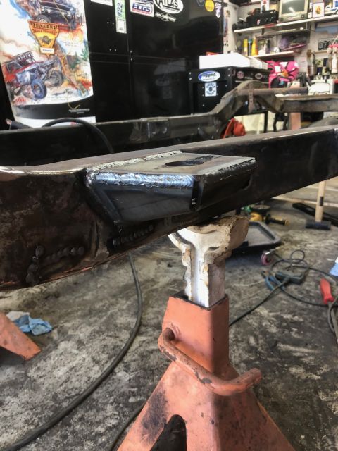1992 Jeep Wrangler - Close-up of a frame repair with fresh welds on jack stands.