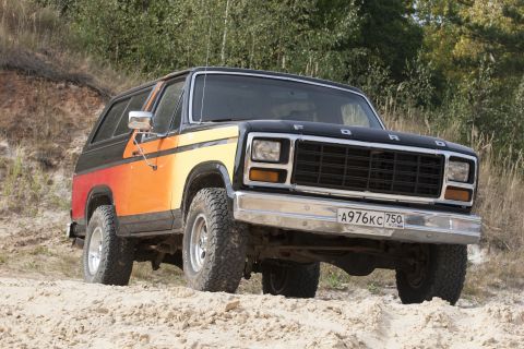 1993 Ford Bronco - This Ford Bronco has a distinctive two-tone paint job with orange and yellow stripes.