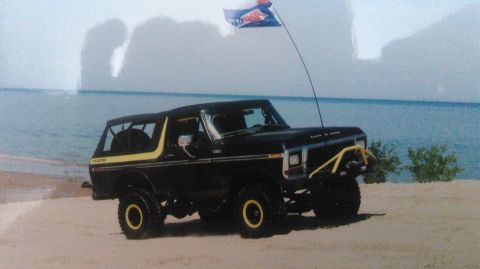 1978 Ford Bronco - This lifted Ford Bronco is ready for adventure, parked on the sand with the ocean in the background.