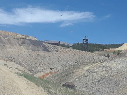 1999 Ford E250 - A view of an old mining site with structures on a hillside.