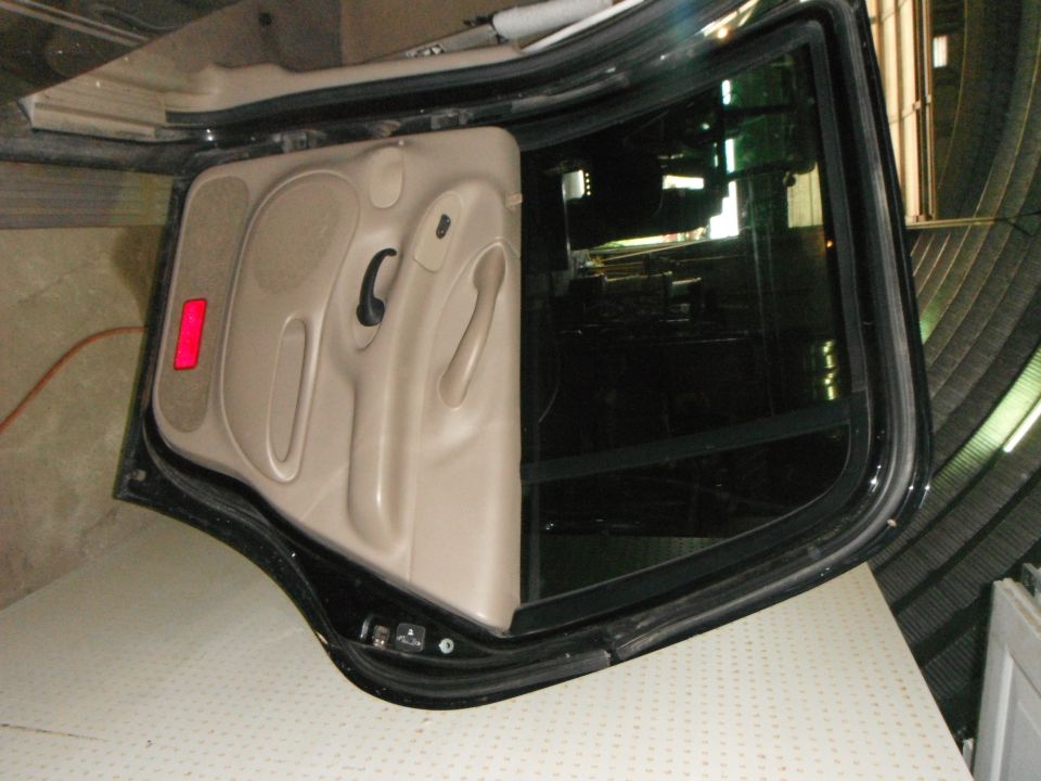 Tan car door panel with red reflector and black window frame, 2001 Ford Expedition