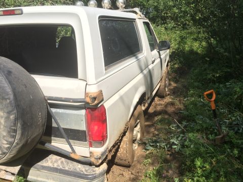 1993 Ford Bronco - This 1993 Ford Bronco is stuck in the mud on a wooded trail.