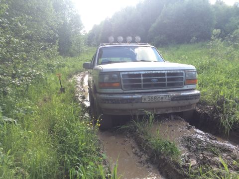 1993 Ford Bronco - This 1993 Ford Bronco is stuck in the mud on a trail, with a shovel visible nearby.