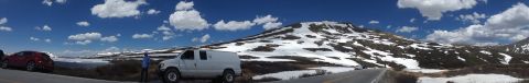 1999 Ford E250 - Two vehicles are parked on the side of a road with a large, snow-capped mountain in the background.
