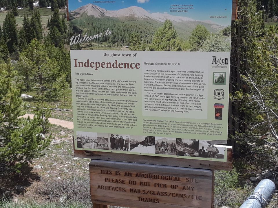 Sign detailing the history and geology of the ghost town of Independence, Colorado, with historical photos