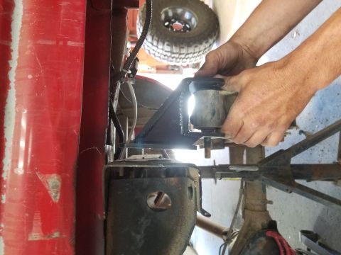1996 Dodge 1500 - Mechanic installs a suspension part on a vehicle, spare tire in background.