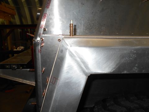 1992 Ford Bronco - Close-up of a metal structure with visible rivets and copper components, indicating construction or repair work.