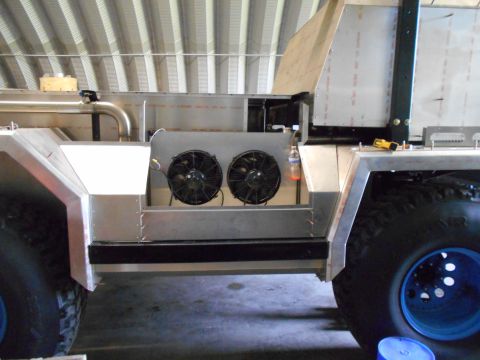1992 Ford Bronco - Custom vehicle construction shows exposed frame, cooling fans, and large off-road tires.