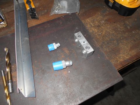 1992 Ford Bronco - Various metal parts and tools are laid out on a workbench surface.