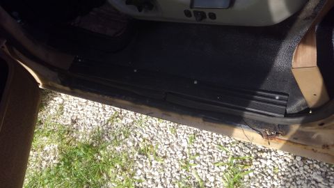 1990 Ford F-250 - View of the interior door sill and floor area of a vehicle.