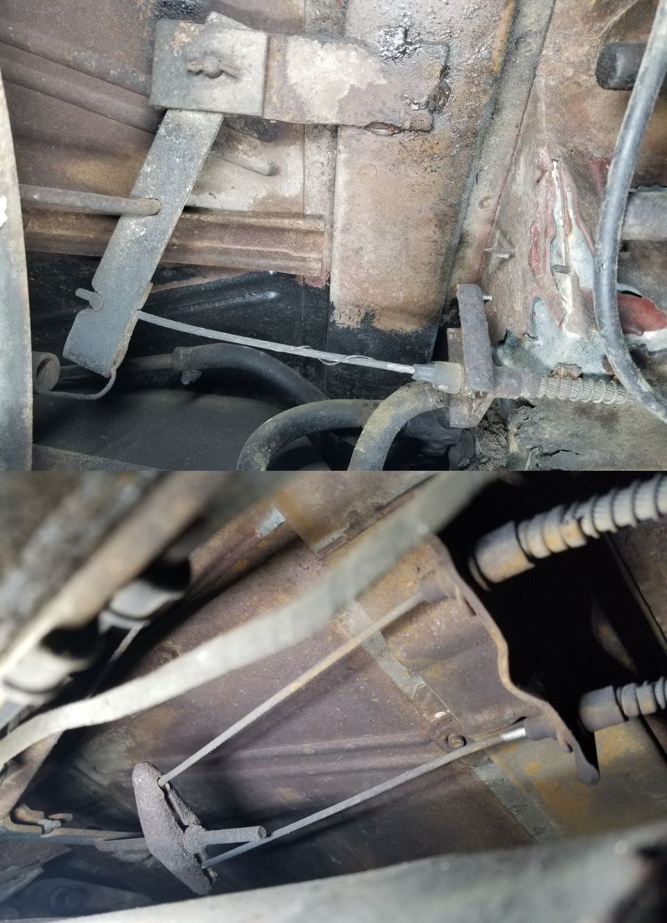 Close-up of a rusty underbody brake cable mechanism with metal brackets and cables