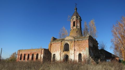 1993 Ford Bronco - An old, dilapidated brick church stands against a clear blue sky. The structure is in ruins, with crumbling walls and a damaged bell tower,…
