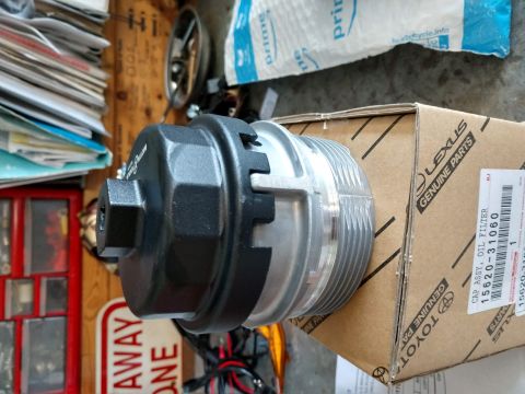 2018 Toyota 4Runner - Oil filter cap wrench tool beside a Lexus Genuine Parts box labeled cap assy oil filter, part 15620-31060