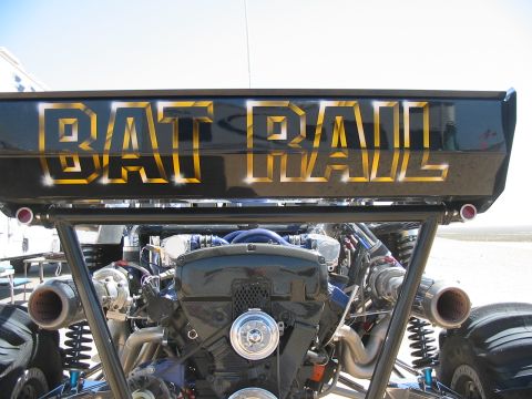 1993 Ford Taurus - The "BAT RAIL" vehicle features a prominent engine and custom gold lettering on its rear.