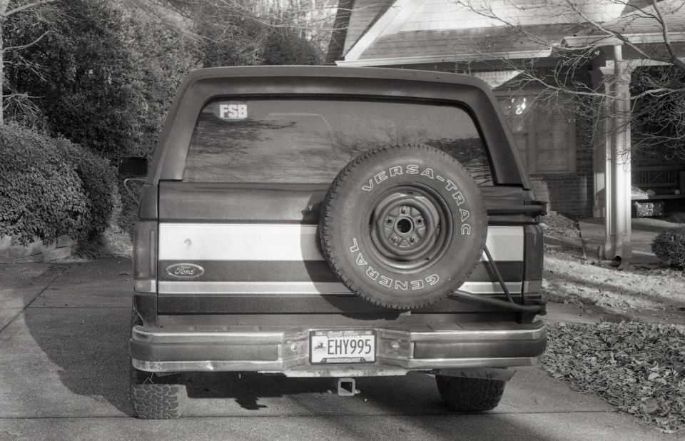 Rear view of a Ford Bronco with a spare tire and license plate EHY995.