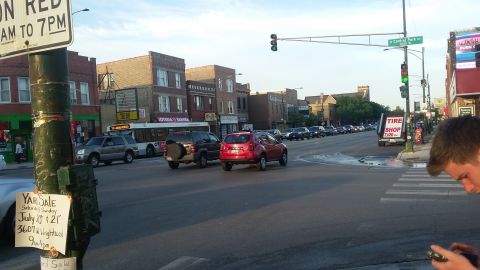 Street intersection with cars and traffic signals in urban neighborhood