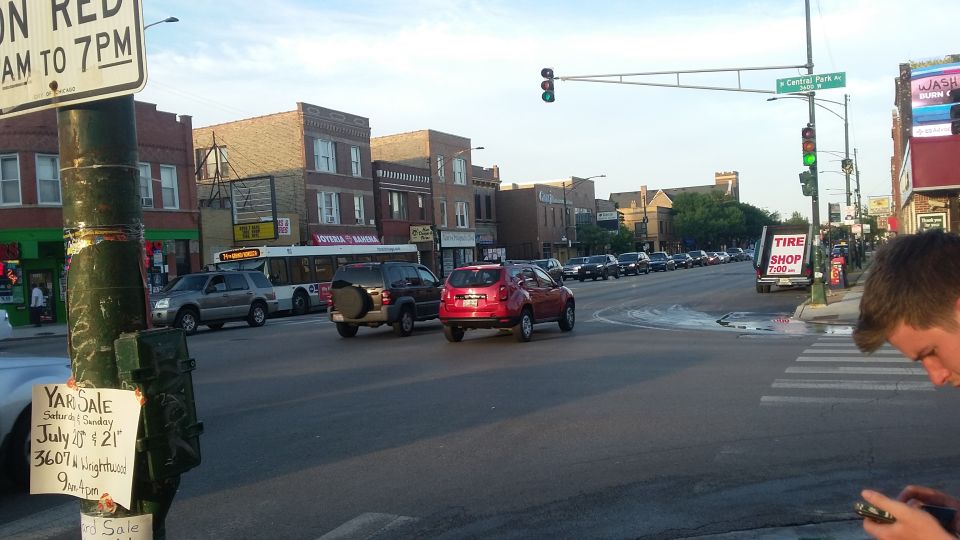 Street intersection with cars and traffic signals in urban neighborhood
