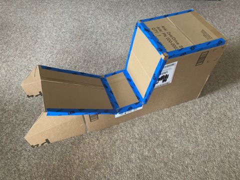 1996 Ford Bronco - A cardboard box has been taped together to form a unique structure, possibly a prototype or custom part.