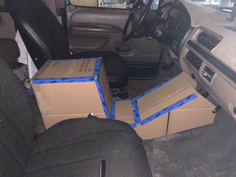1996 Ford Bronco - Boxes are taped together and placed on the floor and seats inside the vehicle.