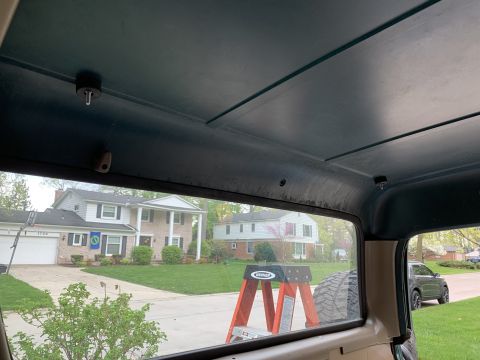 1996 Ford Bronco - View from inside a vehicle, showing houses and a ladder outside.