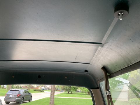 1996 Ford Bronco - View from inside a vehicle shows its ceiling and a Ford Explorer parked outside.