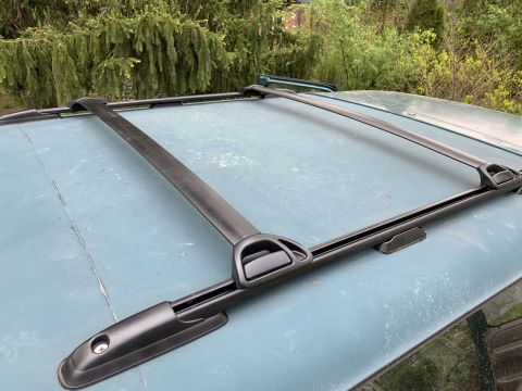 1996 Ford Bronco - Close-up of a roof rack system installed on a vehicle's roof.