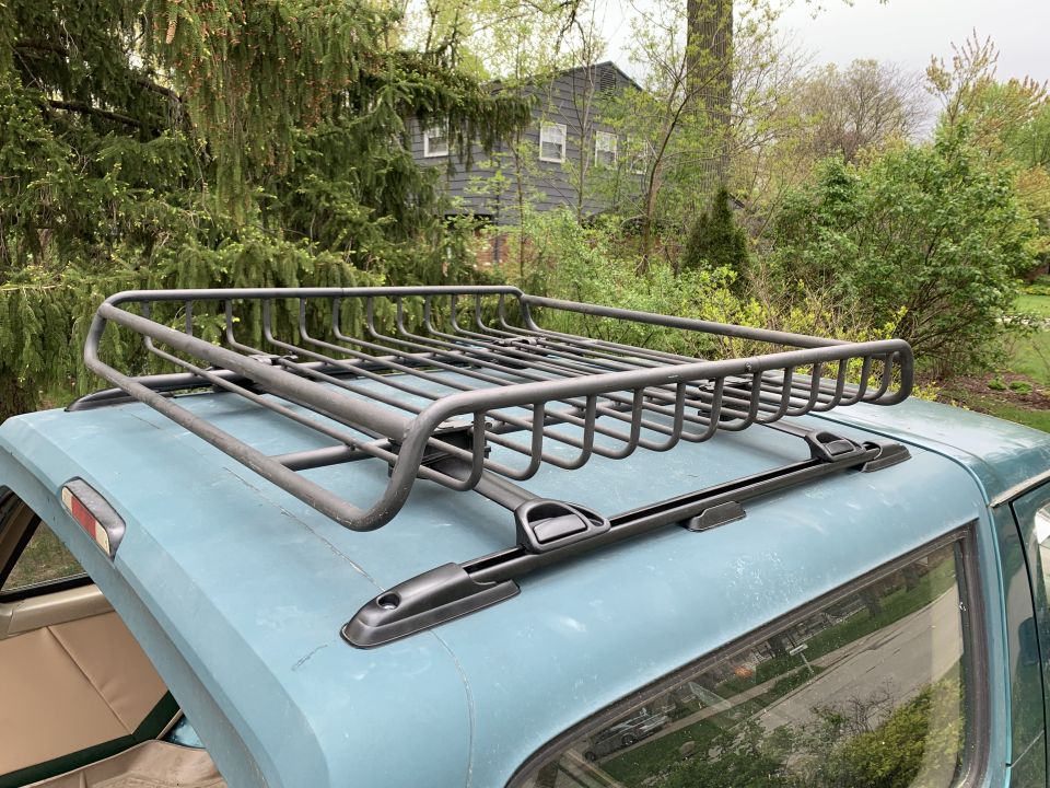 Blue SUV roof with a black cargo rack. Interior visible